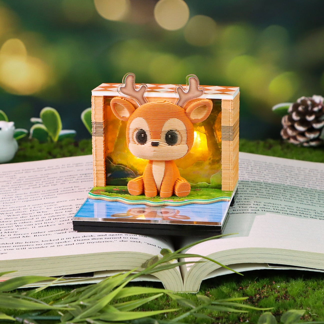 Wooden deer figurine on an open book with a blurred natural background